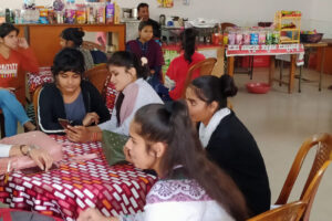 Shagufta, 9, has regularly attended the Save the Children Jigyasa centre for two years. As a result, she was able to enroll in a Delhi municipal school, which she attends each morning, and where she is a student of class four. 
Until attending the centre Shagufta had never been to school and was regularly working attaching the strap to chappal (slippers) sole. They get one rupee for every 12 pairs of chappals.
She lives with her mother, father and eight siblings in a small shanty in the slums positioned directly next to the railway tracks of the Darbhanga area of Inderlok, New Delhi India. 
Shagufta dreams of being a dancer when she grows up.